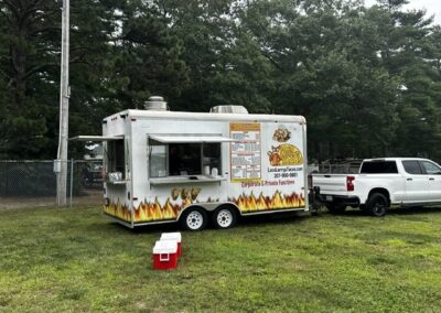 Guests ordering from a food truck at the cornhole fundraiser