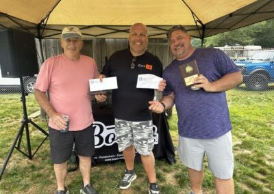 Cornhole tournament winners with their trophy