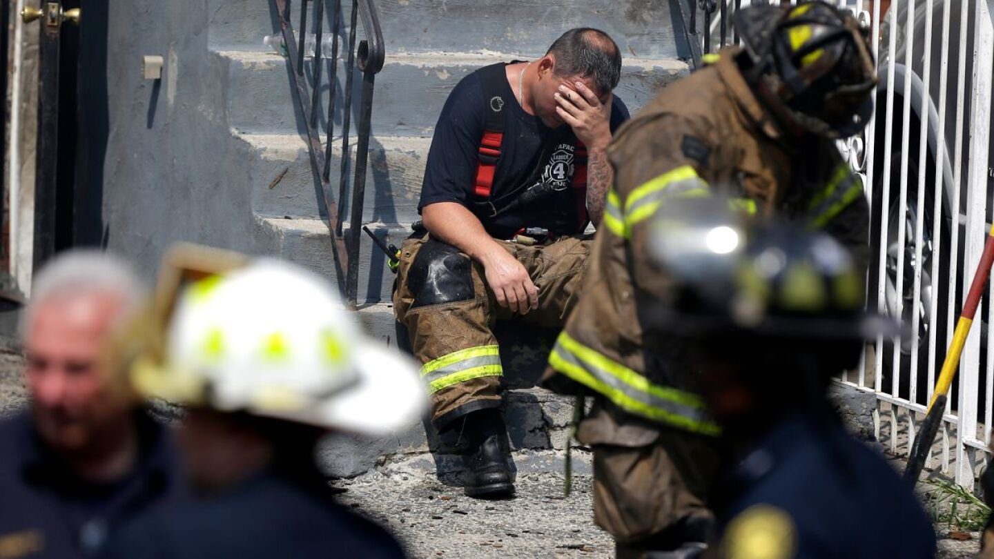 A firefighter comforting a colleague through a critical incident stress reaction after a difficult call
