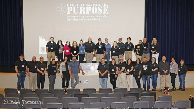 The Plymouth County first responder peer support team on stage at a community event
