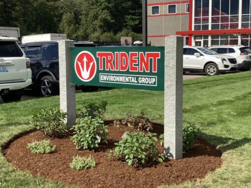 Mulched bed with shrubs around an office park sign