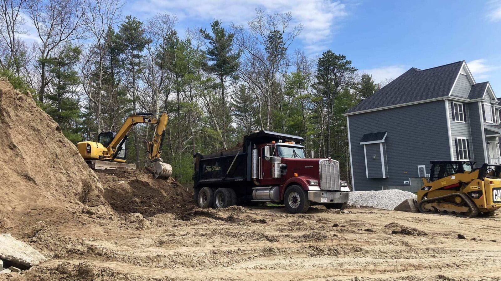 Ten Four excavator, dump truck and skid steer grading a residential site in Norfolk, MA
