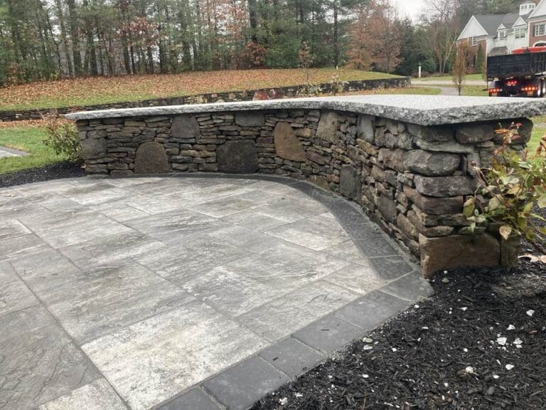 Request a quote for a paver patio and fieldstone seat wall like this one from Ten Four Landscape & Construction