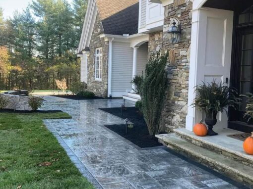 Paver front entry and landing at a stone-and-shingle home