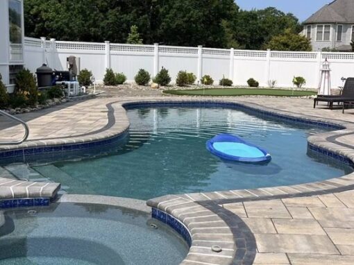 Paver pool deck around an in-ground pool and spa