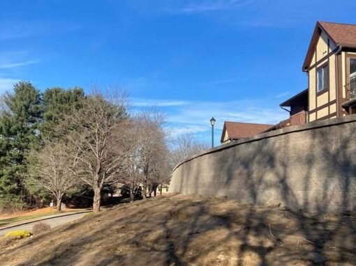 Long concrete retaining wall below condo buildings