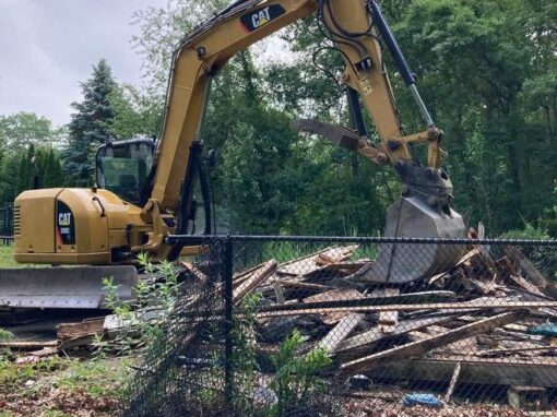 Excavator removing debris from an old structure