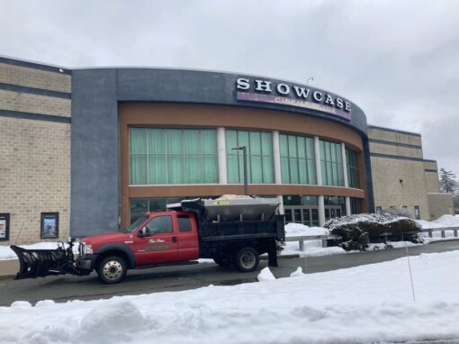 Plow truck on duty at a commercial property in winter