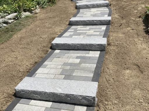 Granite slab treads set into a sloped paver path